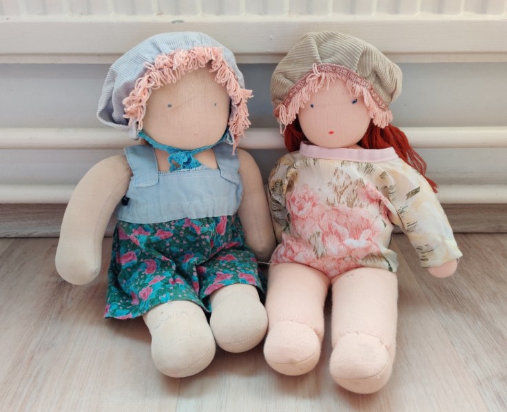 Two Steiner dolls / Waldorf dolls in homemade summer hats. The hats were inspired by a popular TV series of the time called Little House on the Prairie.