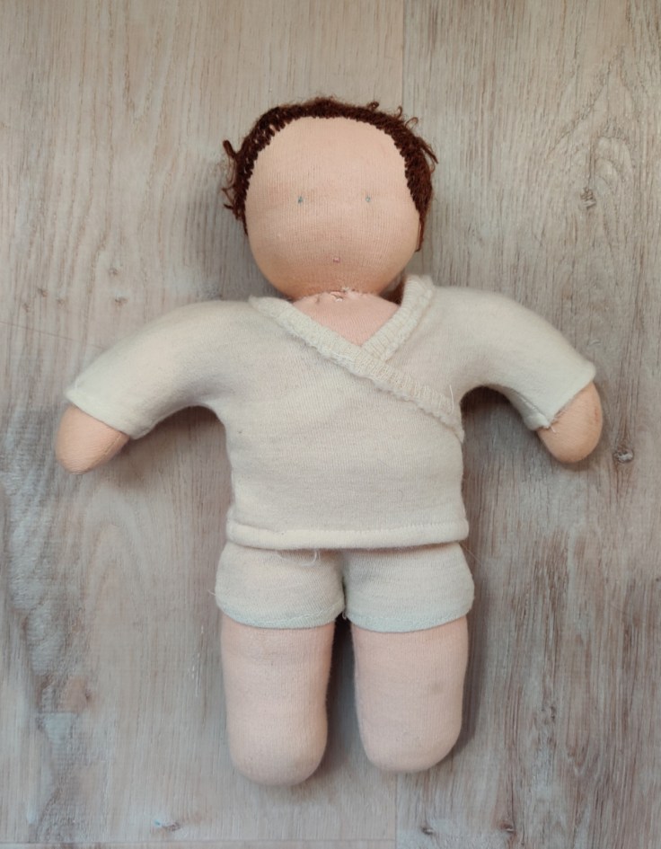 Self-made brown-haired Steiner doll / Waldorf doll from 1993 in its original woolen clothes.